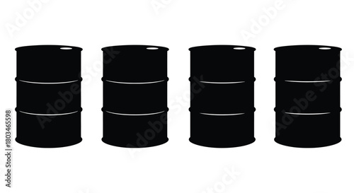 Four black oil barrels are standing next to each other