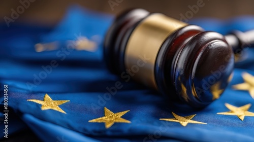 A gavel rests on a blue European Union flag, symbolizing justice and governance within the EU context.