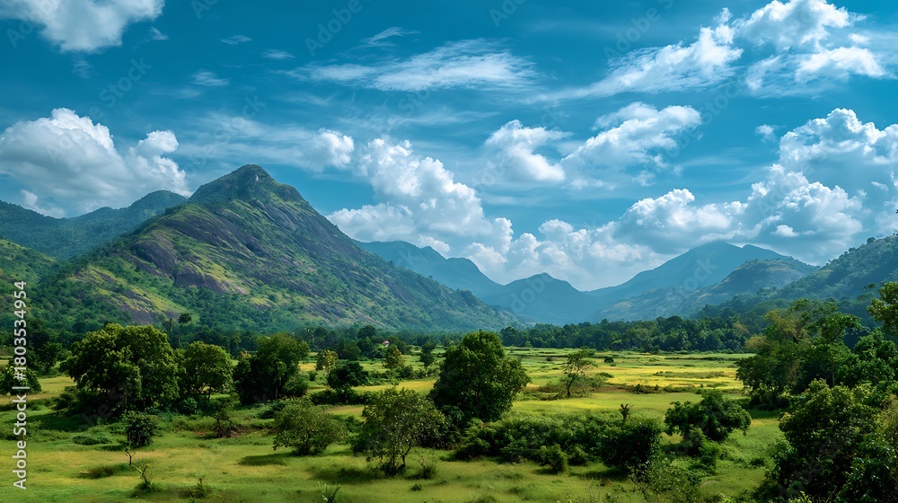 Obraz premium Exploring Green Mountain Valley Landscape with Blue Sky and Clouds