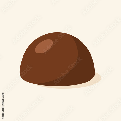 Single chocolate truffle on cream background