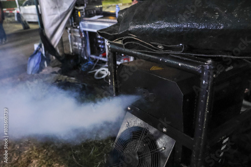 Cuadro en lienzo Portable generator running at night, emitting thick white exhaust smoke