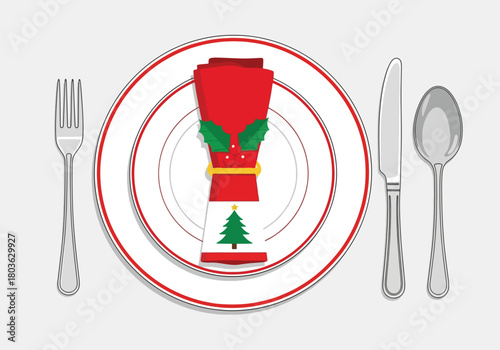 Christmas dinner place setting with a red napkin, holly, tree, fork, knife, spoon, and plate.