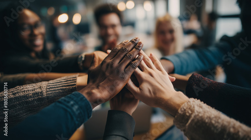 Diverse group of people stacking hands together in a meeting for teamwork and unity