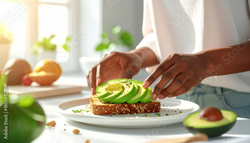 Avocado slices being arranged on toast in bright clean daylight