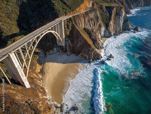 Fototapeta Naklejka Na Ścianę i Meble -   Iconic Bixby Bridge spanning a rugged coastal cliff over a pristine beach in Big Sur, California