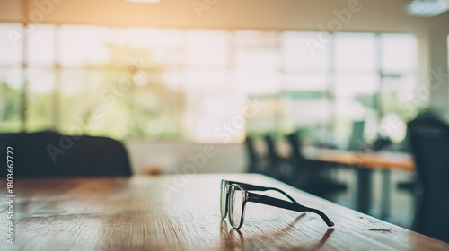 afterhours. A clean wooden desk with eyeglasses, set in a quiet after-hours office atmosphere. pitch deck slides, case study pages, designed for brand storytelling and e-commerce strategy.