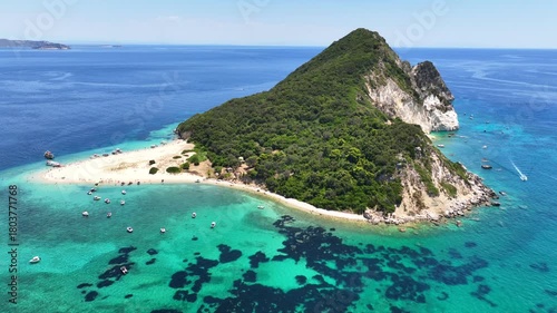Aerial drone cinematic video of paradise bay with scenic white cliffs covered with limestone and sea caves creating a blue lagoon in tropical exotic destination island