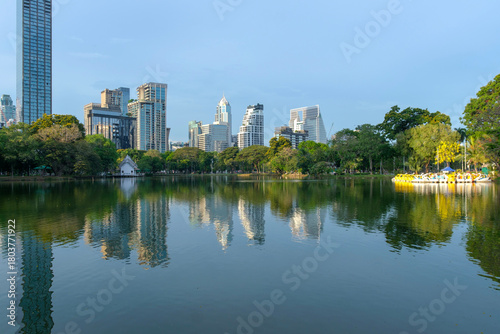 Inside green public center park on Bangkok, Thailand with canals and boats on docking for rent to relax on holidays or after work, surrounded modern buildings