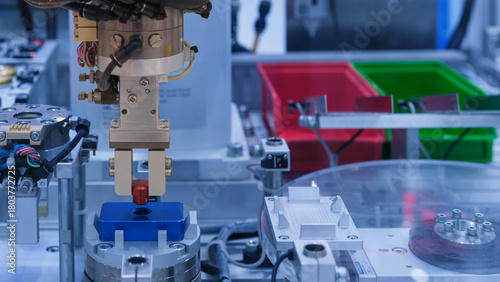 Close up industrial automation robotic working with red metalwork on smart manufacturing and right copy space on blue tone background, industry 4.0 and modern technology