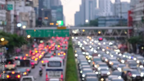 Blurred aerial view from overpass with traffic jam on main road in capital on evening, which is the time rush hour when people get off work