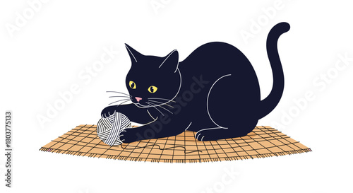 A playful black cat is intently focused on shredding a piece of paper on a woven mat.