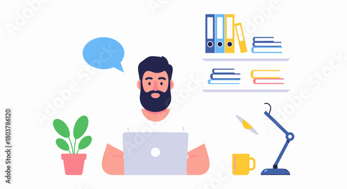 A man with a beard working on a laptop at a desk with a plant and a lamp.