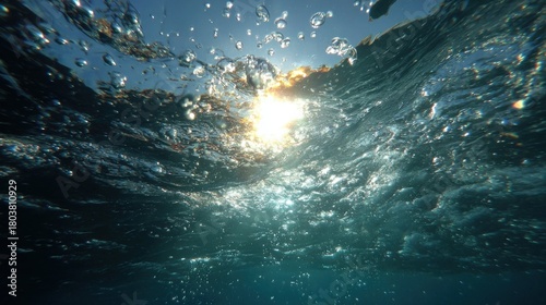 Sunlight shimmering through ocean waves creates a beautiful underwater scene in a coastal area during daytime