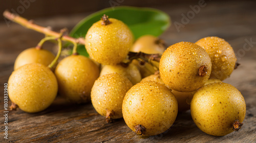 Fototapeta Naklejka Na Ścianę i Meble -  Yellow longan fruits with water drops on wood surface.