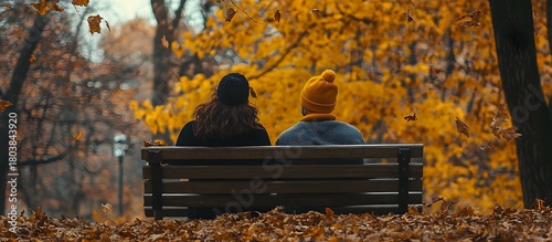 Serene autumn scene with a couple sitting on a park bench