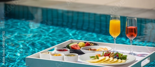Indulge in a luxurious breakfast spread with refreshing drinks by the sparkling poolside, a perfect escape for relaxation and indulgence.