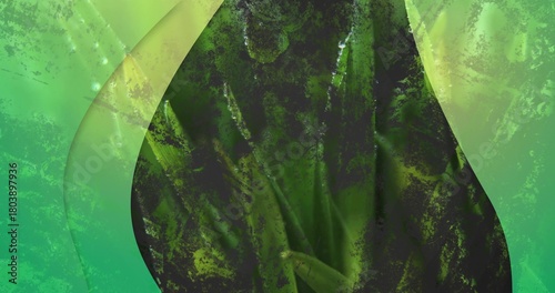 Displaying large dark green teardrop form in closeup with sheer curved panels and speckled grain