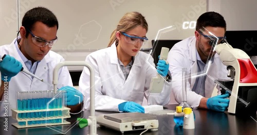 Lab team starting run for assay, pipetting and viewing while AR hex tracking plate and microscope