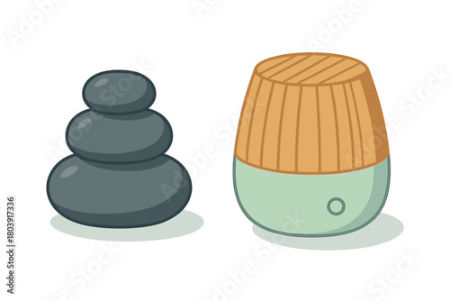 Set of spa and relaxation items with stacked dark stones and wooden aroma humidifier