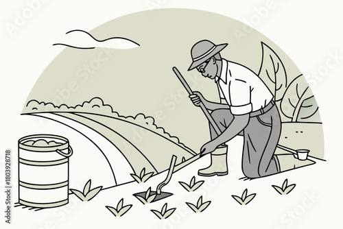 A farmer working in a field cleaning weeds with a hoe