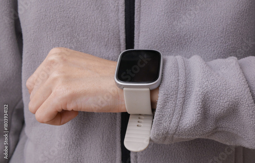 Workout accessories. Smart bracelet on a fitness woman's wrist. Active lifestyle, sport outfit