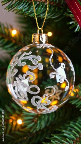 Decorative glass Christmas ornament hanging on tree branches  