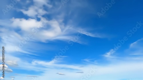 Bright blue sky filled with wispy white clouds on a clear sunny day