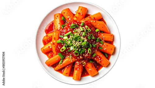 Spicy rice cakes (tteokbokki) topped with scallions and sesame seeds