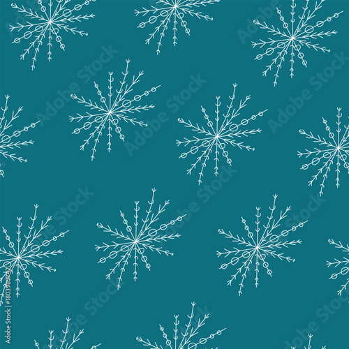 Seamless pattern of snowflakes on an emerald background, winter background