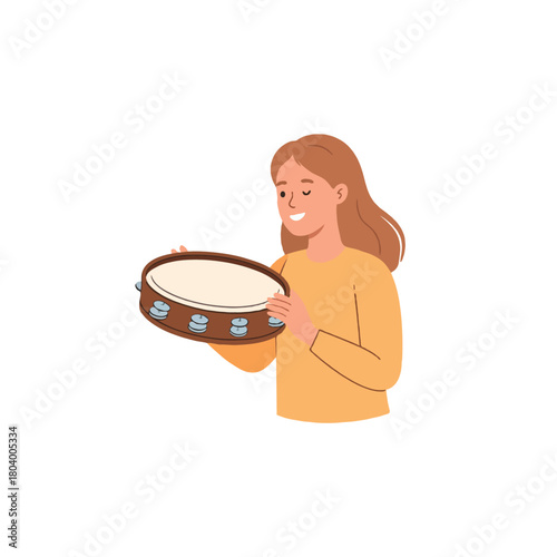 Charming young woman joyfully playing a tambourine creating a playful melody and festive