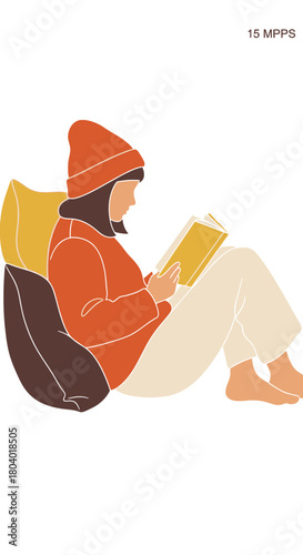 Person wearing a hat reading a book while sitting on cushions.