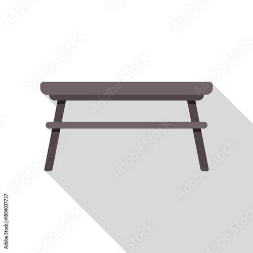 Simple wooden coffee table with a shelf below, casting a long shadow, perfect for minimalist interiors