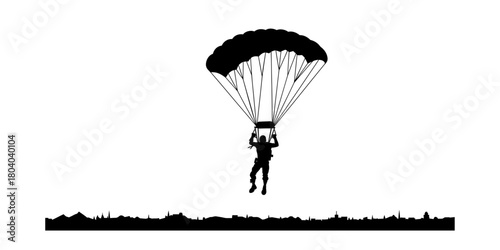 Silhouette of a paratrooper descending with an open parachute.