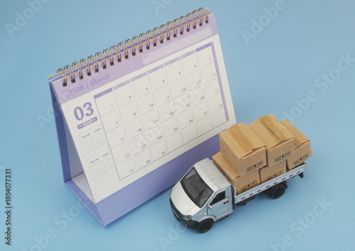 Lorry truck with many boxes and calendar on blue  background. Shipping, delivery, cargo, moving and freight transportation schedule concept.