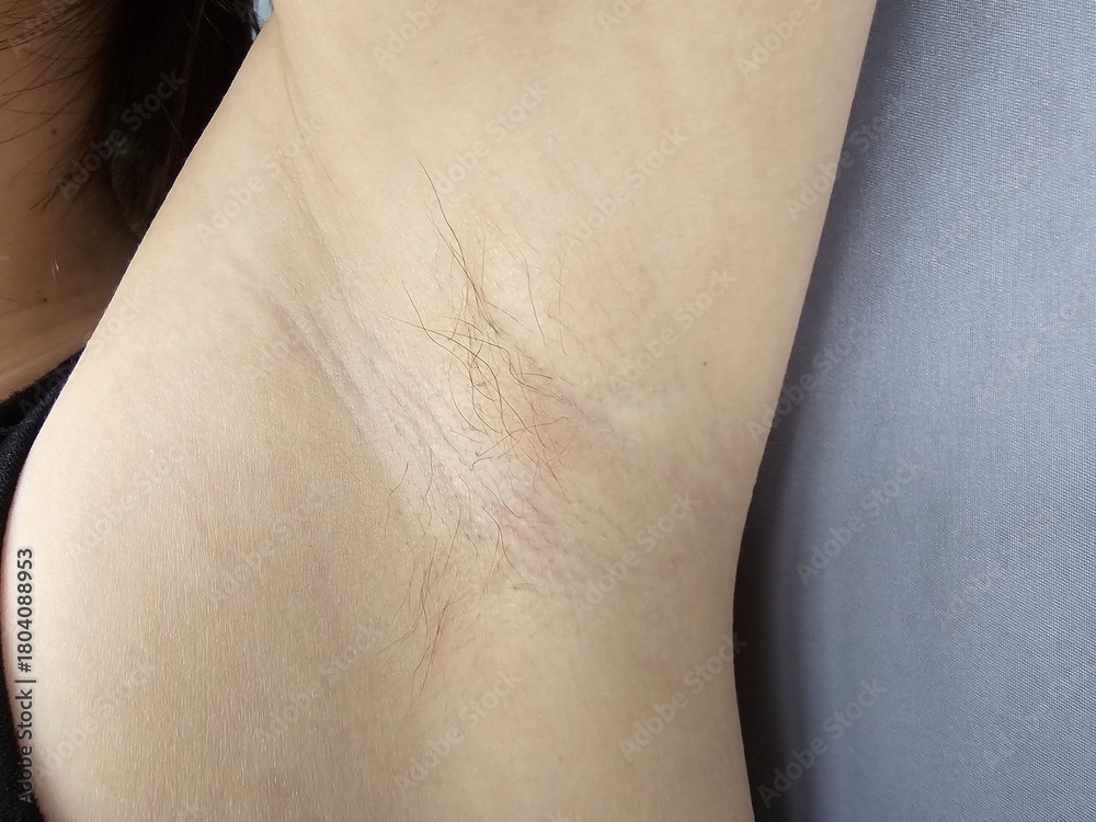 Fototapeta premium Closeup view of a person's underarm skin showing light hair growth and natural tones concept