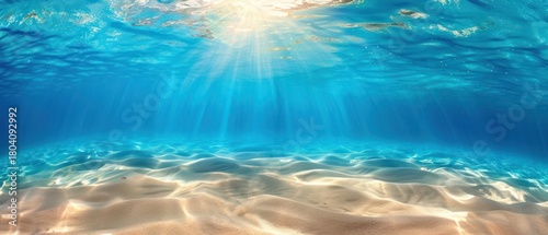 Seabed sand with blue ocean summer sun shining bright calm sea water ripples.