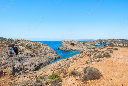 Cliff viewpoint with a panoramic view of the coast of Comino island and its islets in the Mediterranean sea, MALTA