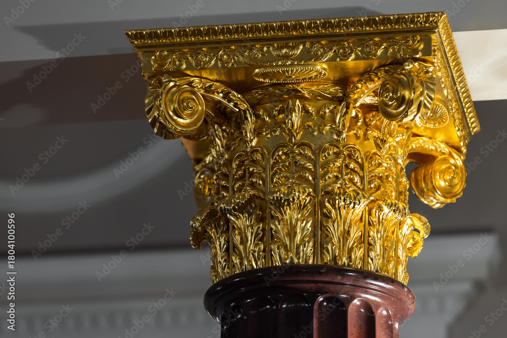 Fototapeta premium A richly detailed gold-leaf Corinthian capital with acanthus leaves and ornate scrolls