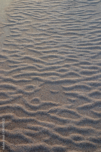 Wavy beach sand wind ripple pattern texture background