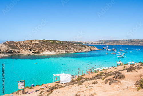 Panorama of the cliff coast with Blue Lagoon, Cominotto beach and Gozo island in the background, Comino MALTA 