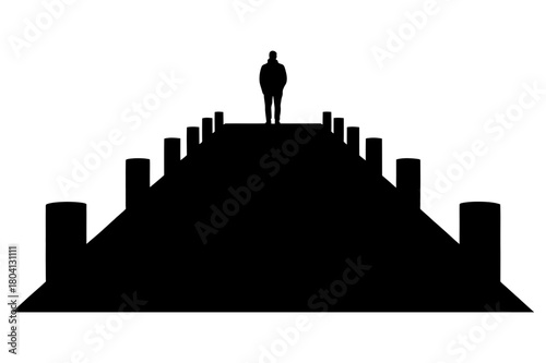 Silhouette of a person standing at the end of a long dark pier with posts on either side in stark contrast