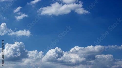 Time-lapse of White clouds sweeping across the sky, revealing the calm beauty of a bright day.