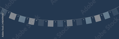 A string of blue and white striped flags hanging against a dark blue background in a curved arrangement