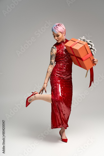 Festive winter wonderland moment with a beautiful young woman and her cheerful gift