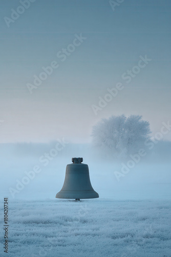 solitary bell ringing in christmas atmosphere surrounded by morning fog and tranquility
