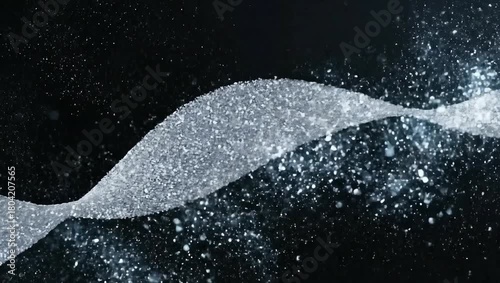 Glittering silver particles forming a dynamic wave on a dark background.