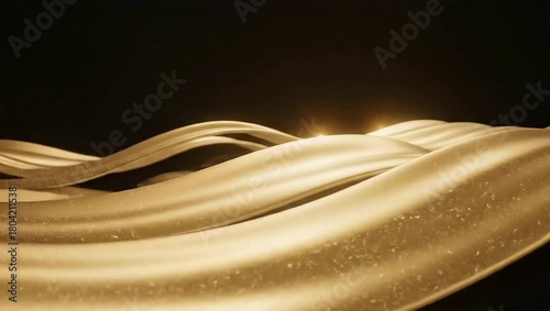 Golden ribbons flowing gracefully against a dark background, creating an elegant and dynamic visual effect.