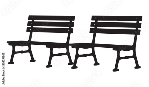  Two empty black wooden slatted park benches with cast iron legs arranged side by side
