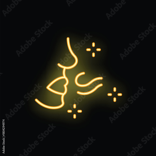 Yellow neon sign of a couple kissing romantically with sparks around them