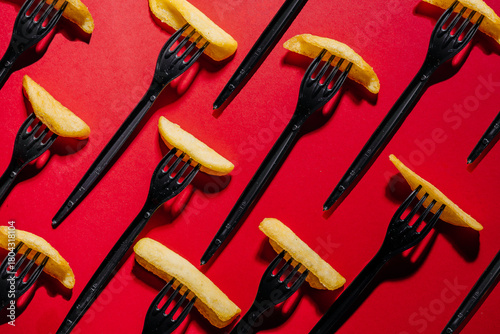 Abstract Pattern of French Fries on Forks Over Fiery Red Background